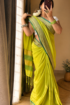 Roshni Raw Mango mulmul cotton saree with green gold zari border — close-up drape view