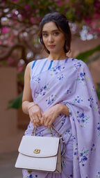 Close up of Neerja lavender bloom saree drape and cobalt-striped blouse — scalloped border detail, digital floral print clusters visible