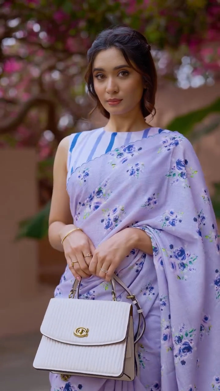 Close up of Neerja lavender bloom saree drape and cobalt-striped blouse — scalloped border detail, digital floral print clusters visible